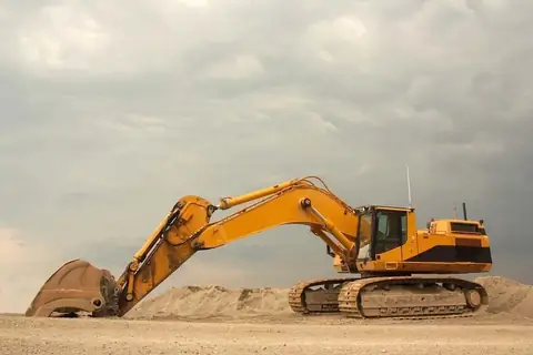 Large excavator on a dirt pile