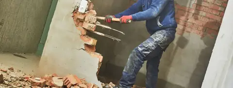 Interior demolition: breaking out a brick wall