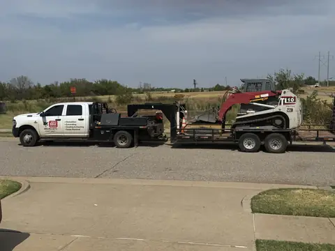 Mike's Bobcat Service truck towing the Takeuchi TL10 on a trailer